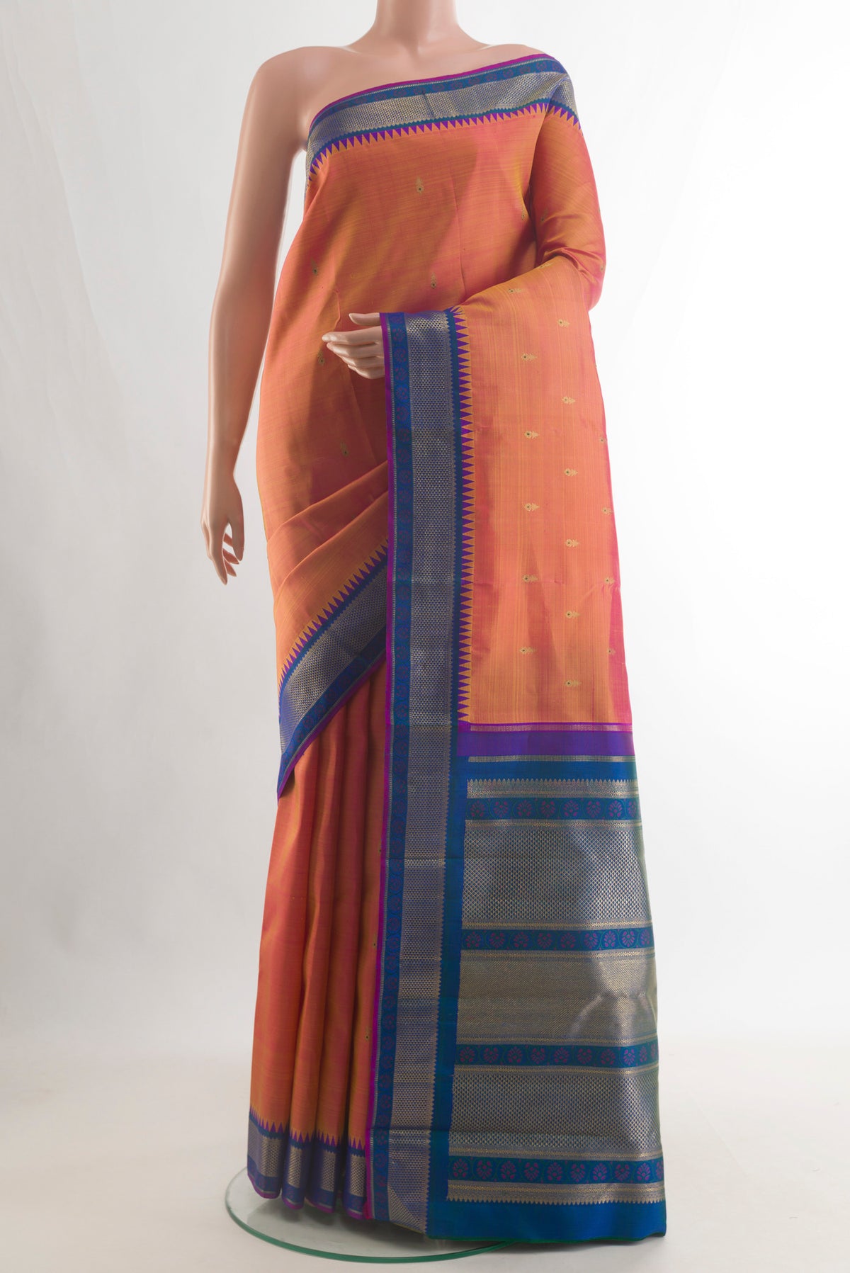 Pure Silk Pure Zari Peach Kanjivaram Saree with Zari Butta on the body and Zari Border.  displayed on a mannequin