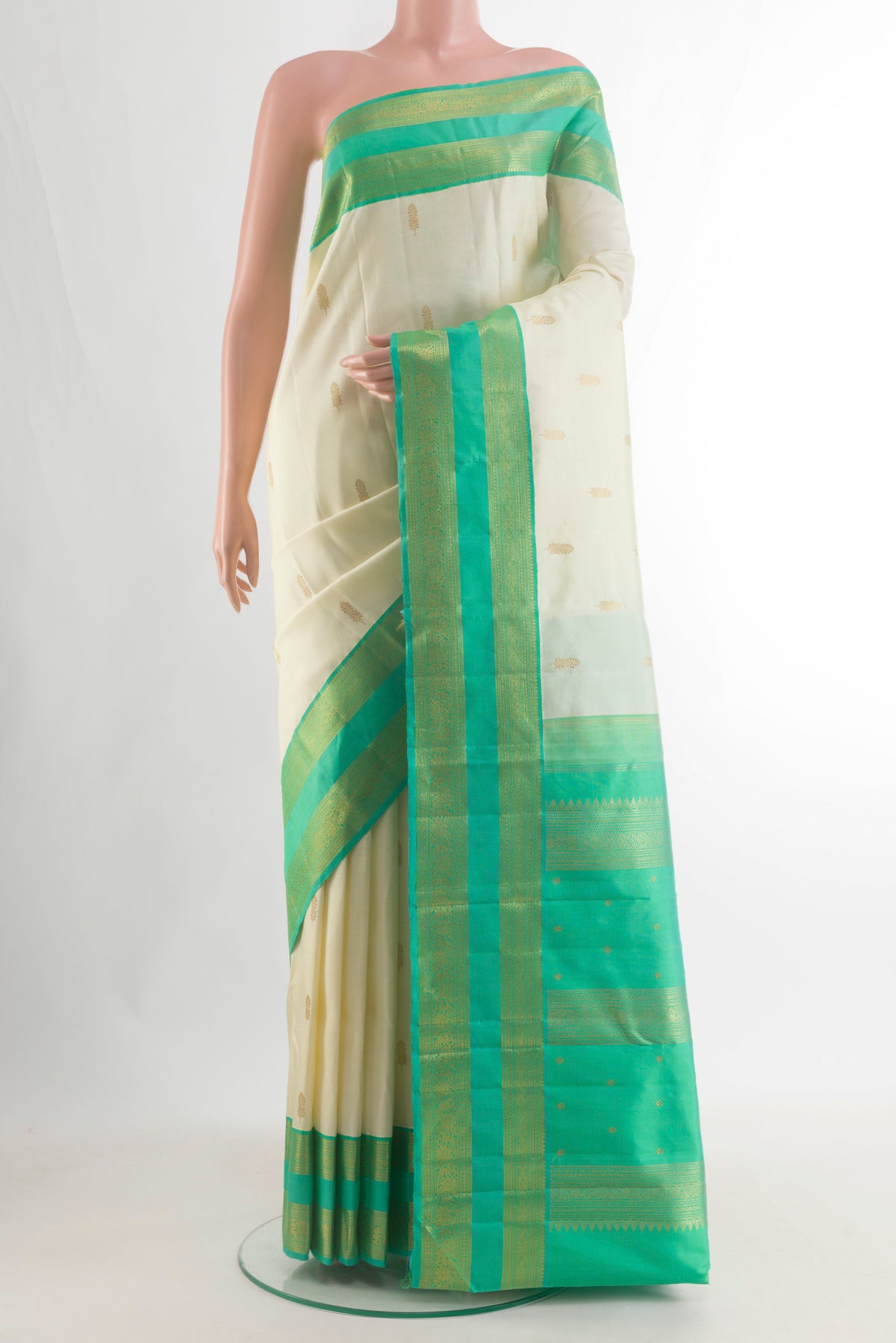Pure Silk Pure Zari Off White Kanjivaram Saree with Zari Butta on the body and Zari Border.  displayed on a mannequin