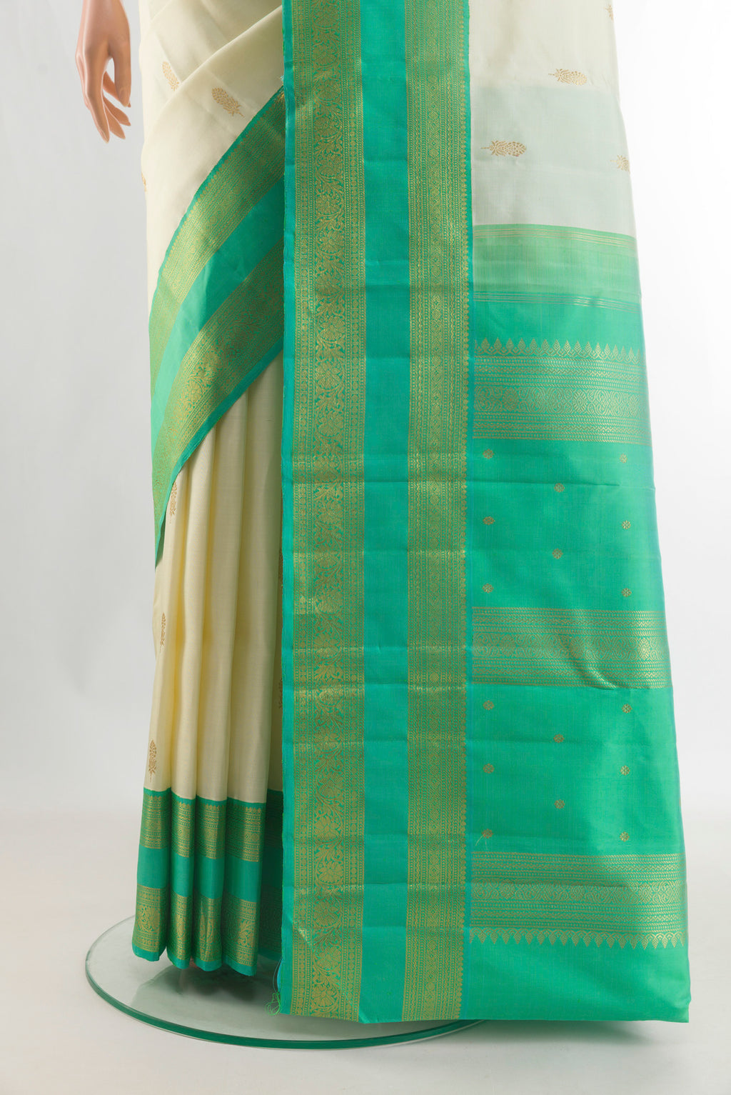Pleats and pallu of Pure Silk Pure Zari Off White Kanjivaram Saree with Zari Butta on the body and Zari Border. 