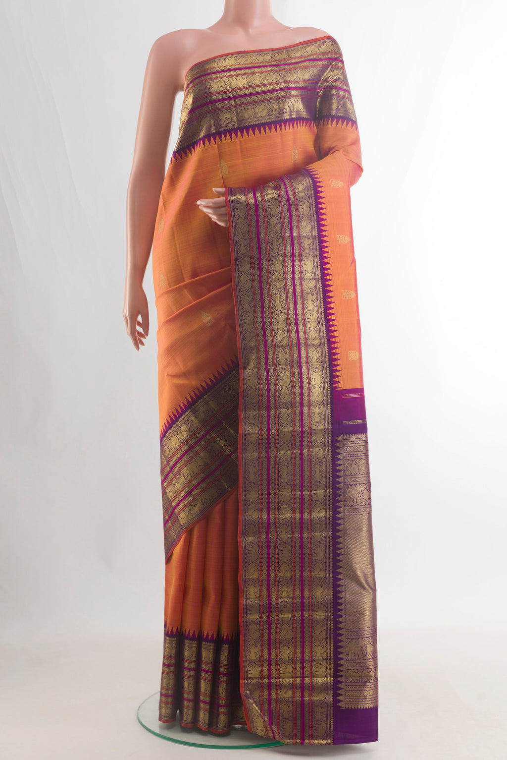 Pure Silk Pure Zari Brick Orange Kanjivaram Saree with Zari Butta on the body and Zari Border.  displayed on a mannequin