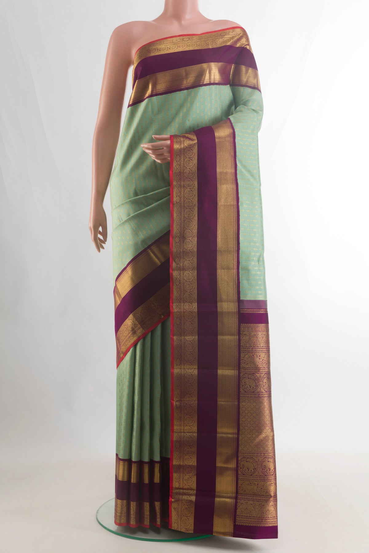 Pure Silk Pure Zari Light Green Kanjivaram Saree with Checked design on the body and Zari Border.  displayed on a mannequin