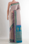 Pure Silk Pure Zari Beige Kanjivaram Saree with Checked design on the body and Zari Border.  displayed on a mannequin