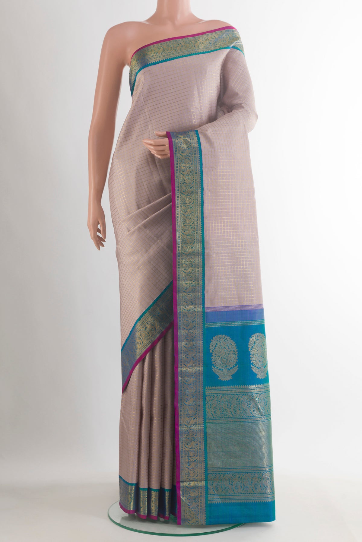 Pure Silk Pure Zari Beige Kanjivaram Saree with Checked design on the body and Zari Border.  displayed on a mannequin
