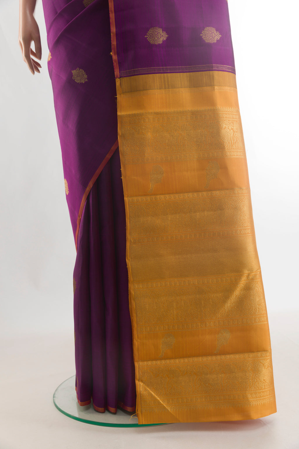 Pleats and pallu of Pure Silk Pure Zari Purple Kanchipuram Saree with Zari Butta on the body and Without Border. 
