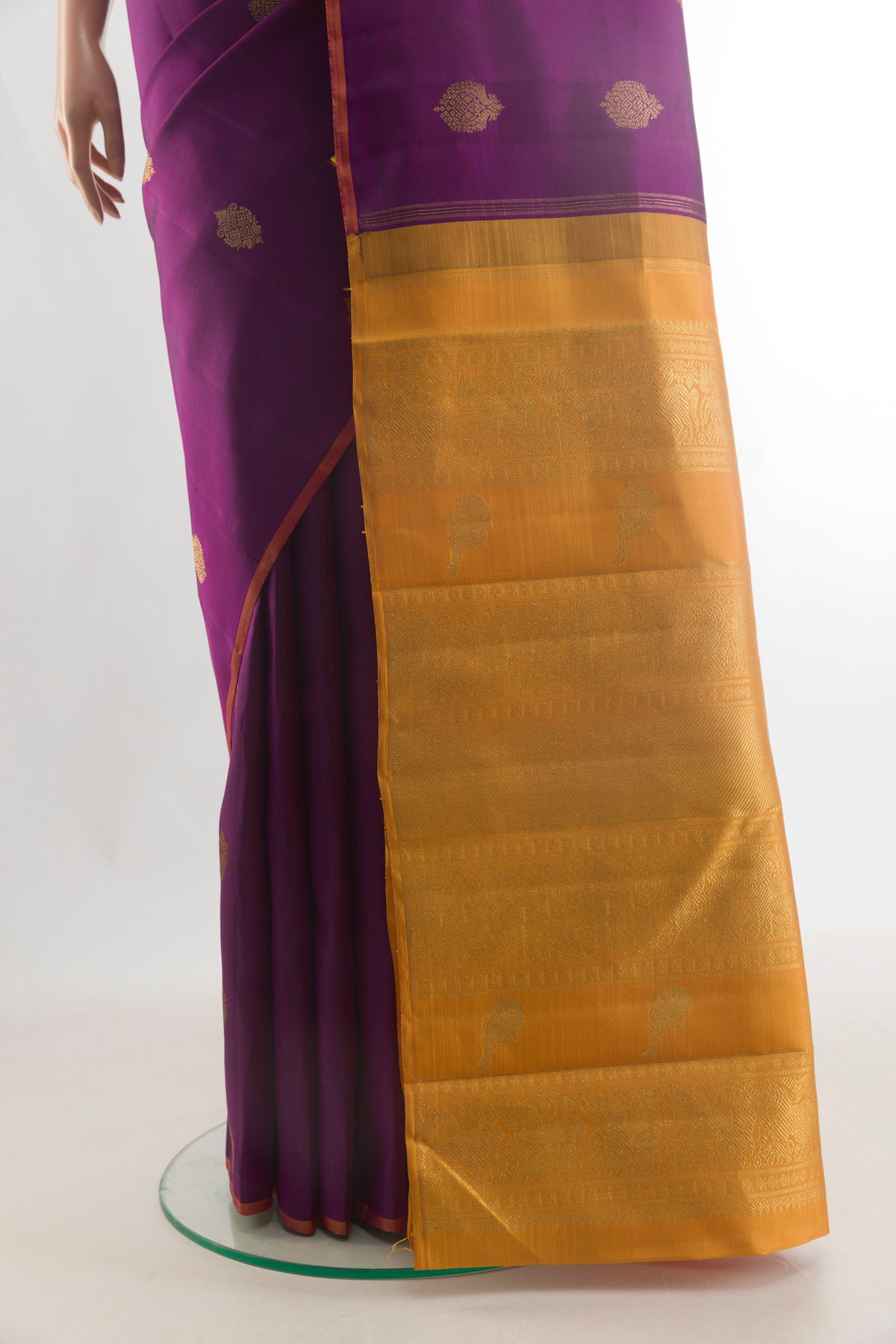 Pleats and pallu of Pure Silk Pure Zari Purple Kanchipuram Saree with Zari Butta on the body and Without Border. 
