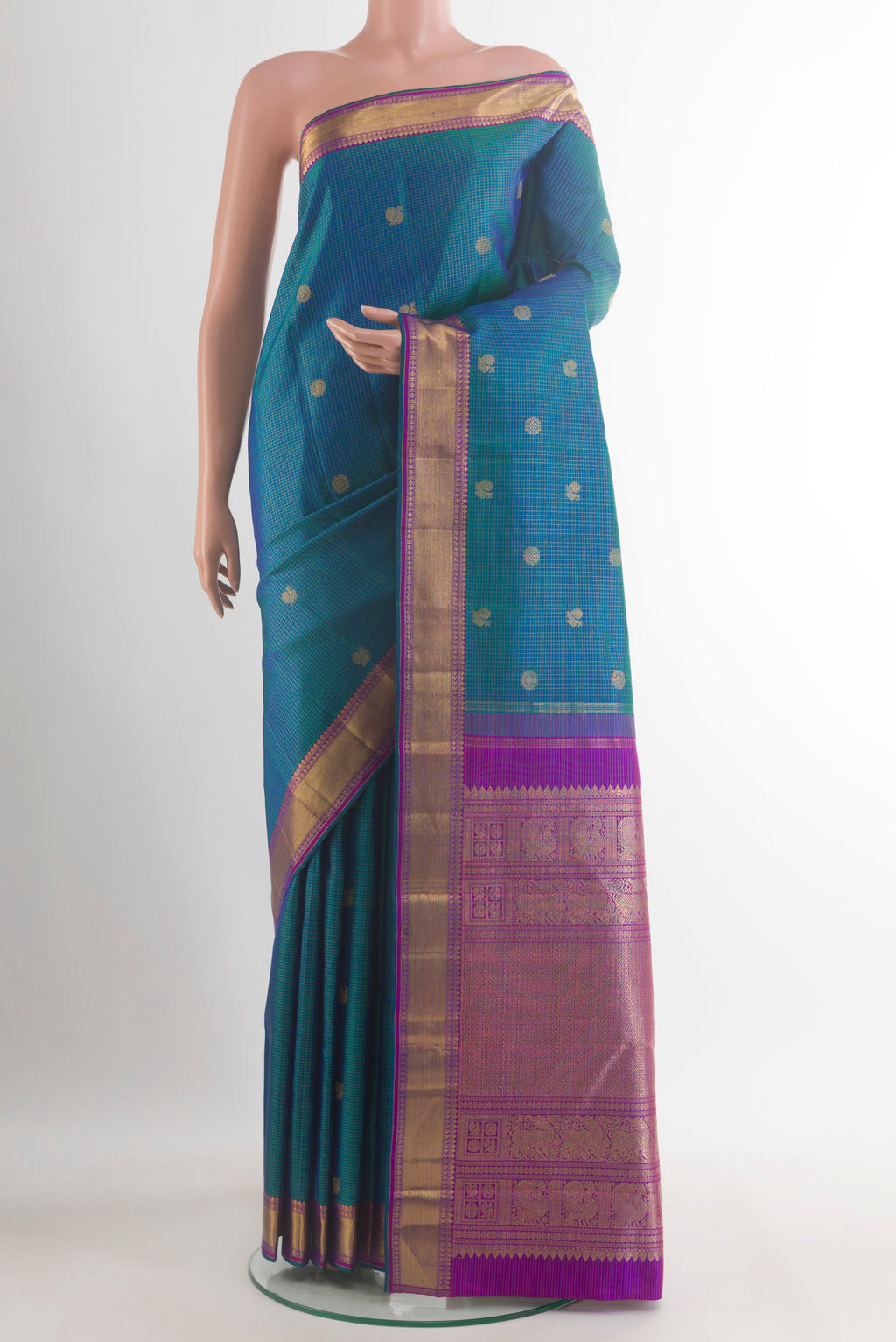 Pure Silk Pure Zari Peacock Blue Kanjivaram Saree with Zari Butta on the body and Zari Border.  displayed on a mannequin