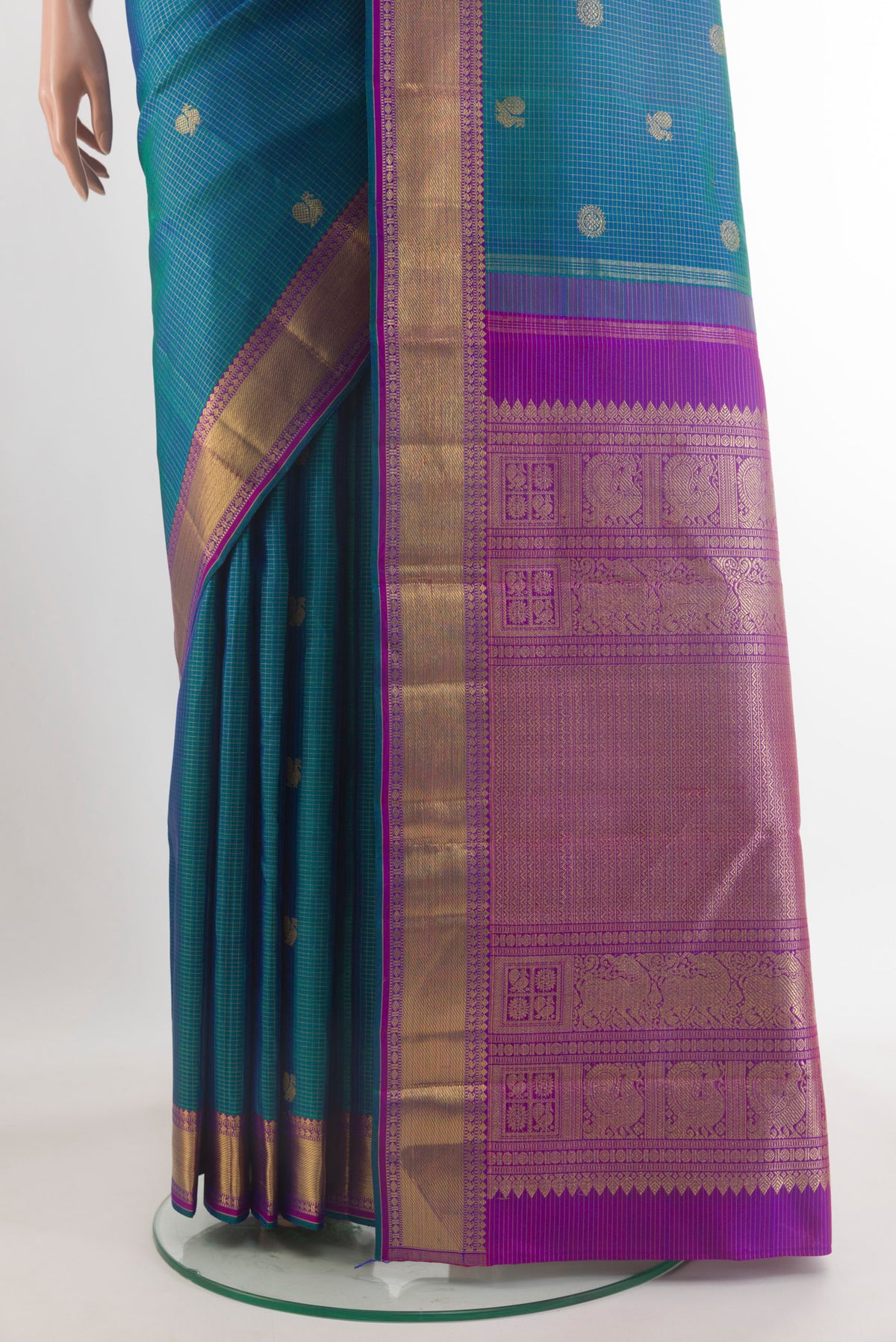 Pleats and pallu of Pure Silk Pure Zari Peacock Blue Kanjivaram Saree with Zari Butta on the body and Zari Border. 