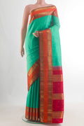 Pure Silk Pure Zari Sea Green Kanjivaram Saree with Zari Butta on the body and Zari Border.  displayed on a mannequin