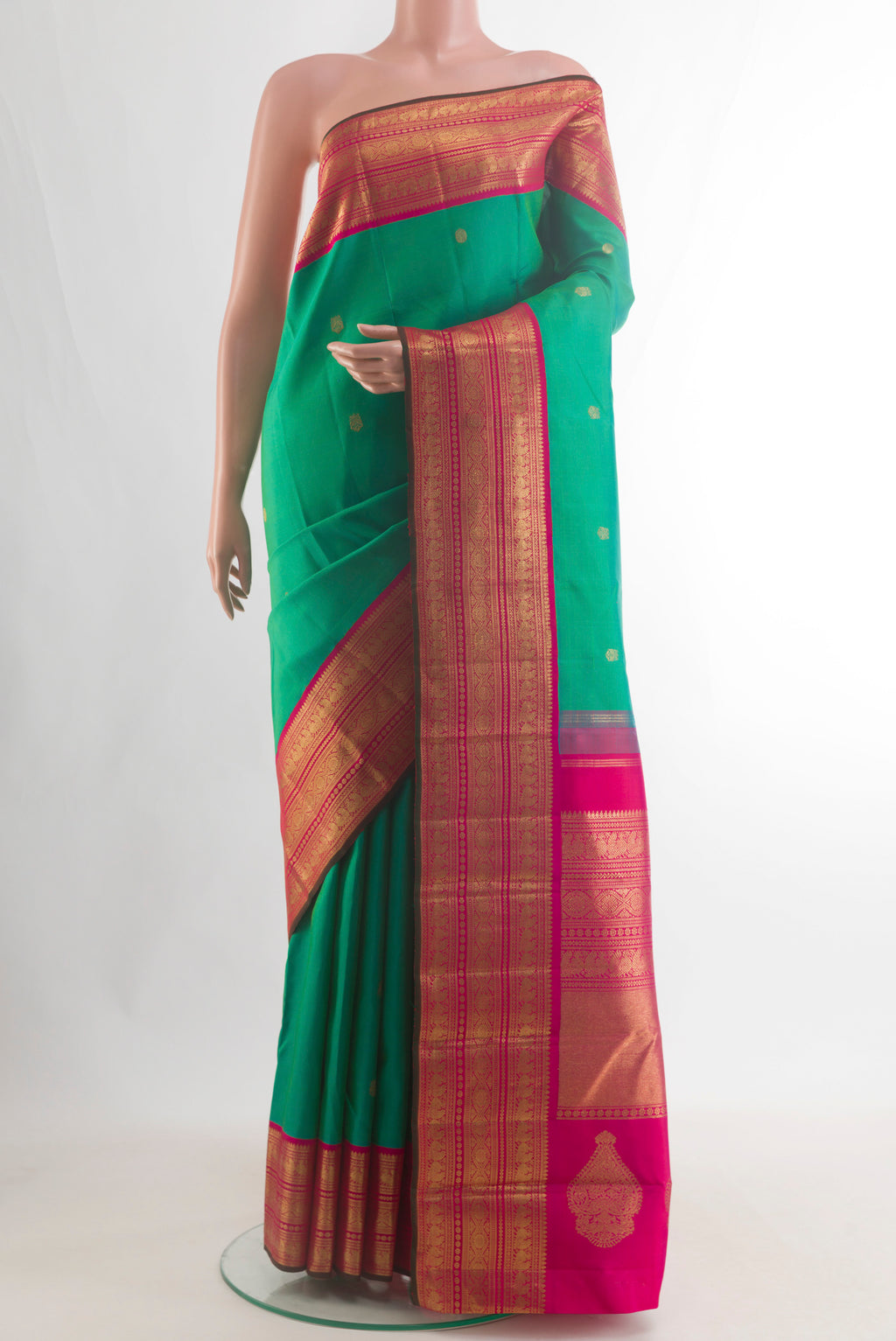 Pure Silk Pure Zari Green Kanjivaram Saree with Zari Butta on the body and Zari Border.  displayed on a mannequin