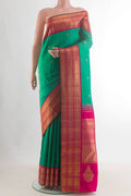 Pure Silk Pure Zari Green Kanjivaram Saree with Zari Butta on the body and Zari Border.  displayed on a mannequin