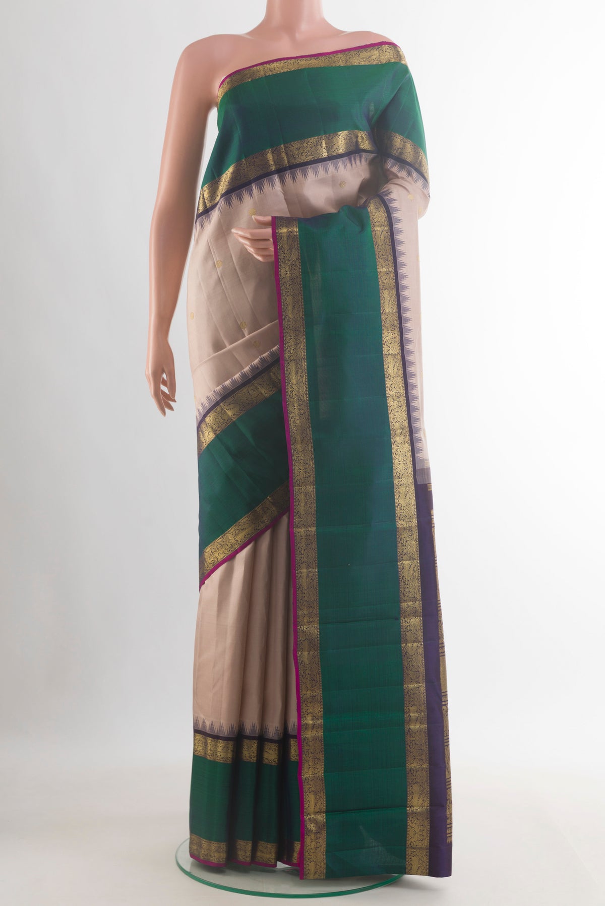 Pure Silk Pure Zari Cream Kanjivaram Saree with Zari Butta on the body and Zari Border.  displayed on a mannequin