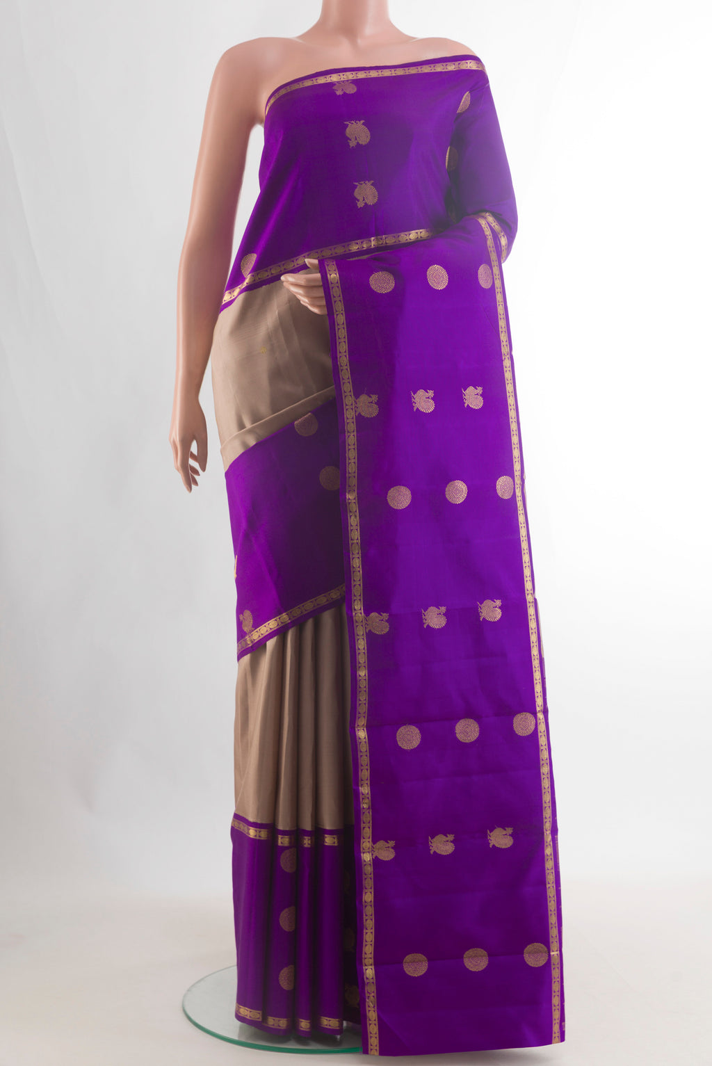 Pure Silk Pure Zari Beige Kanjivaram Saree with Zari Butta on the body and Zari Border.  displayed on a mannequin