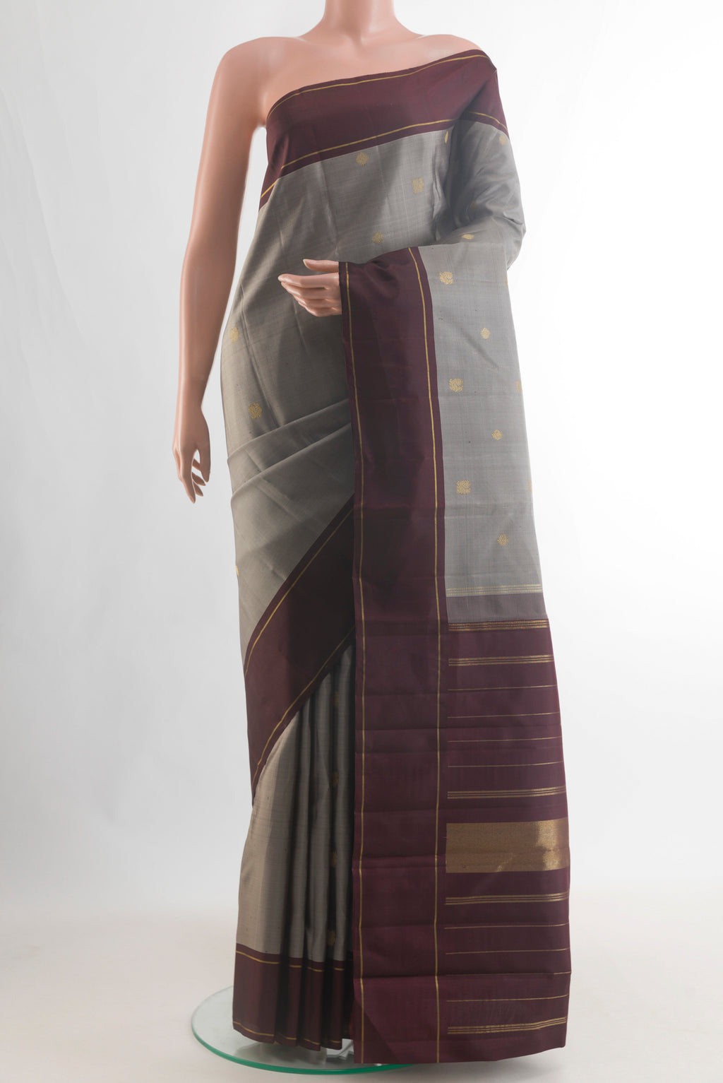 Pure Silk Pure Zari Grey Kanjivaram Saree with Zari Butta on the body and Plain Border.  displayed on a mannequin