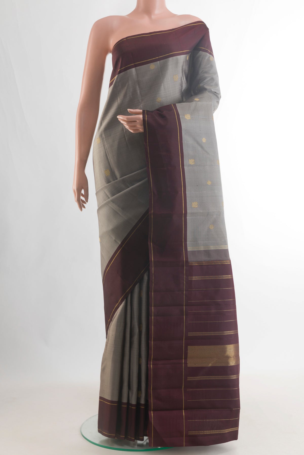 Pure Silk Pure Zari Grey Kanjivaram Saree with Zari Butta on the body and Plain Border.  displayed on a mannequin
