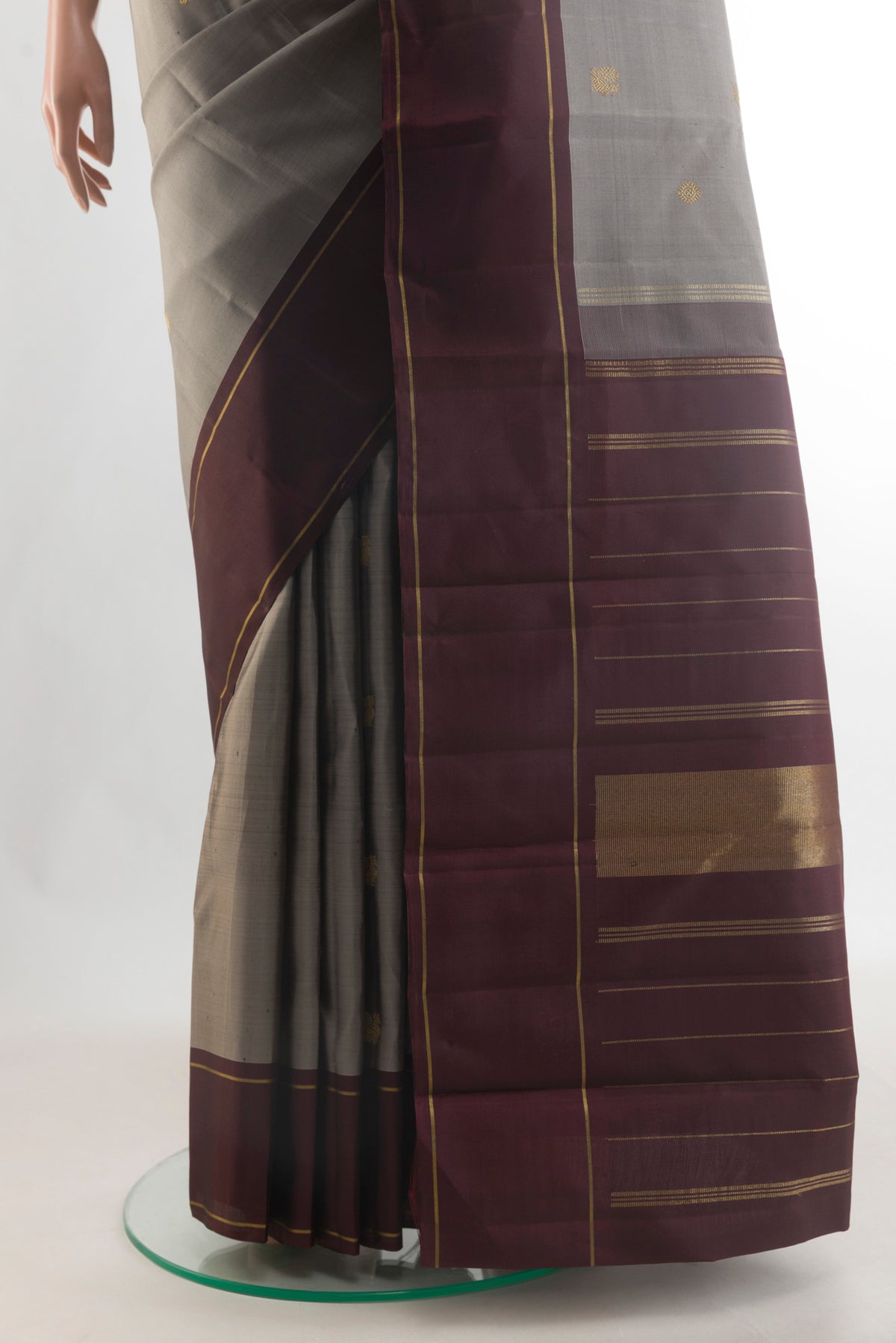 Pleats and pallu of Pure Silk Pure Zari Grey Kanjivaram Saree with Zari Butta on the body and Plain Border. 