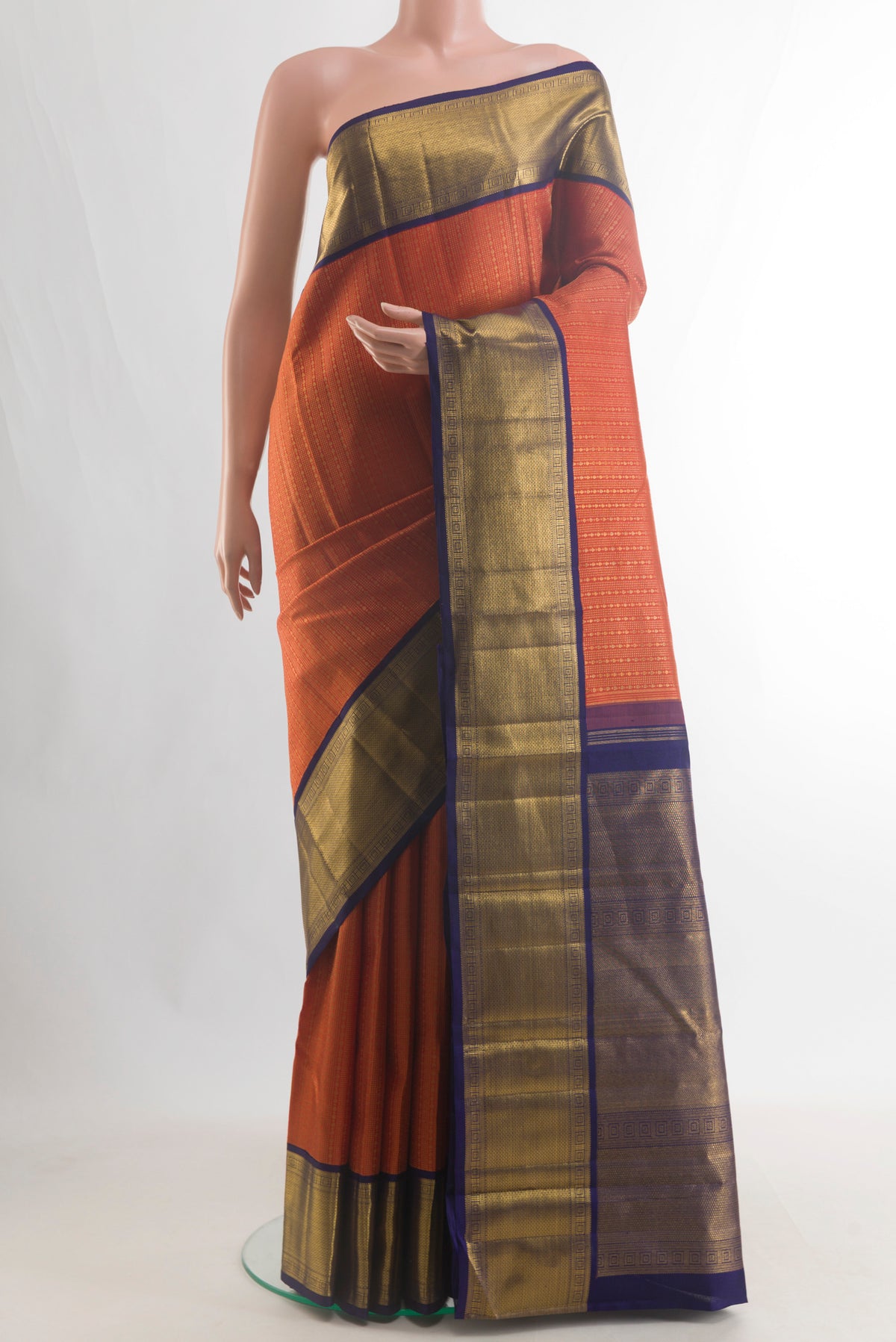 Pure Silk Pure Zari Orange Kanjivaram Saree with Zari Brocade on the body and Zari Border.  displayed on a mannequin