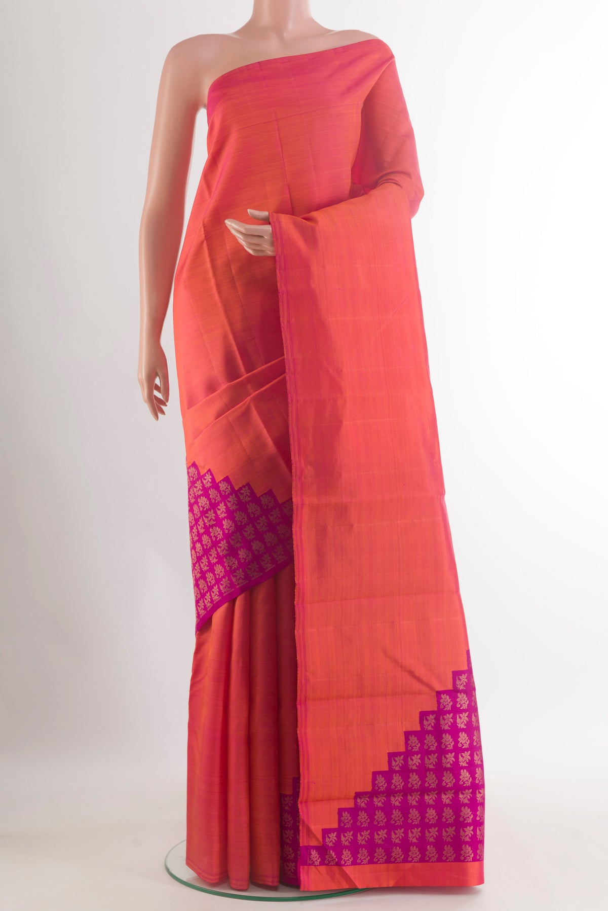 Pure Silk Pure Zari Brick Orange Kanchipuram Saree with Plain Body and Without Border.  displayed on a mannequin