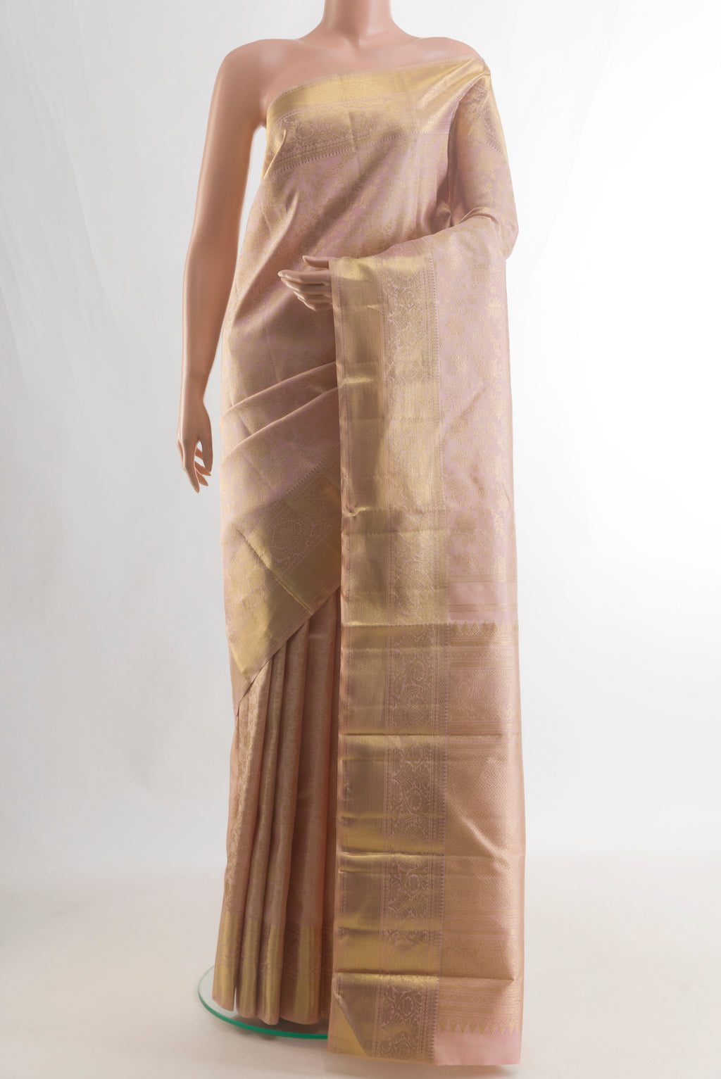 Pure Silk Pure Zari Peach Kanjivaram Saree with Zari Brocade on the body and Zari Border.  displayed on a mannequin