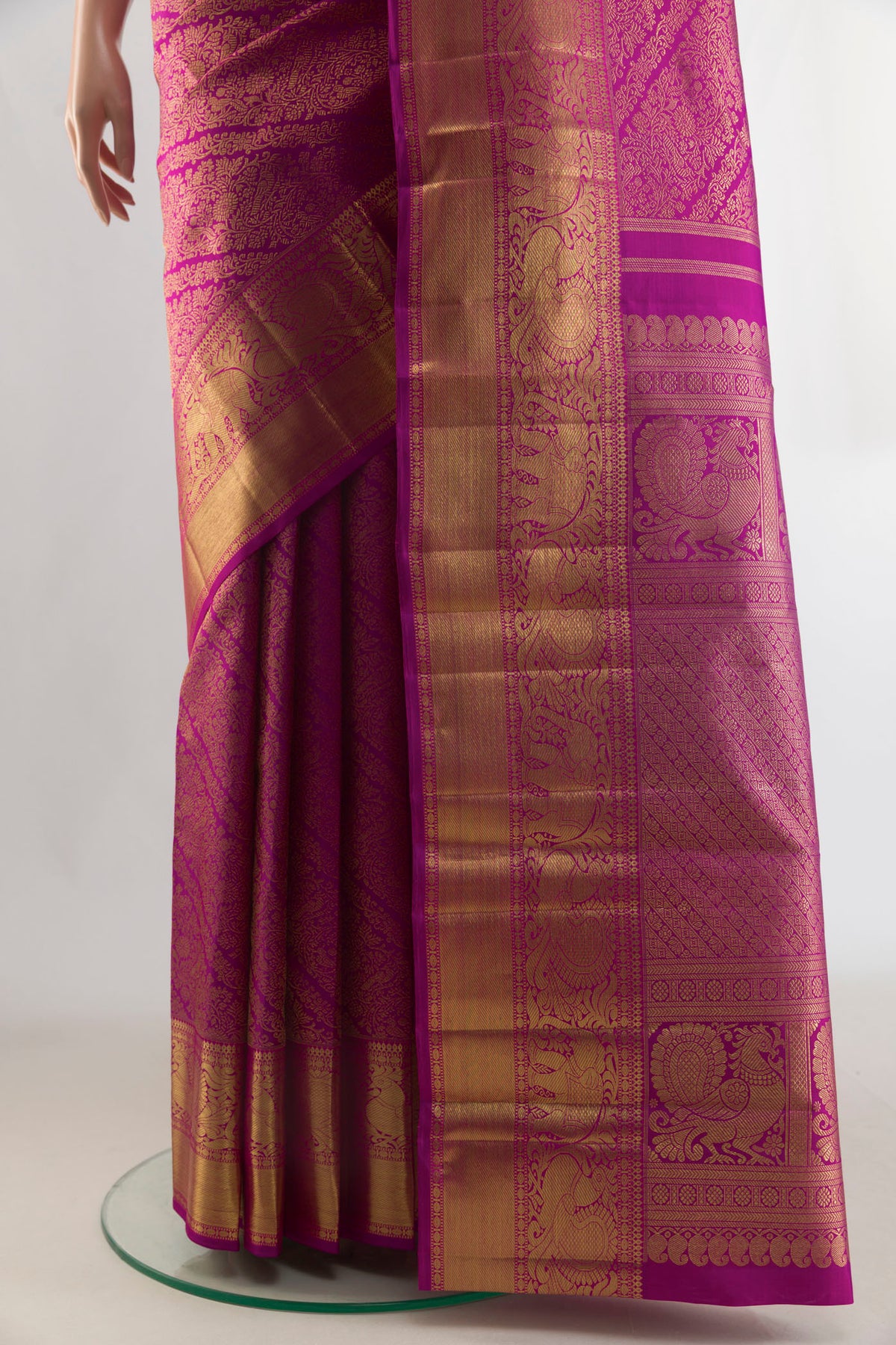 Pleats and pallu of Pure Silk Pure Zari Rani Pink Kanjivaram Saree with Zari Brocade on the body and Zari Border. 