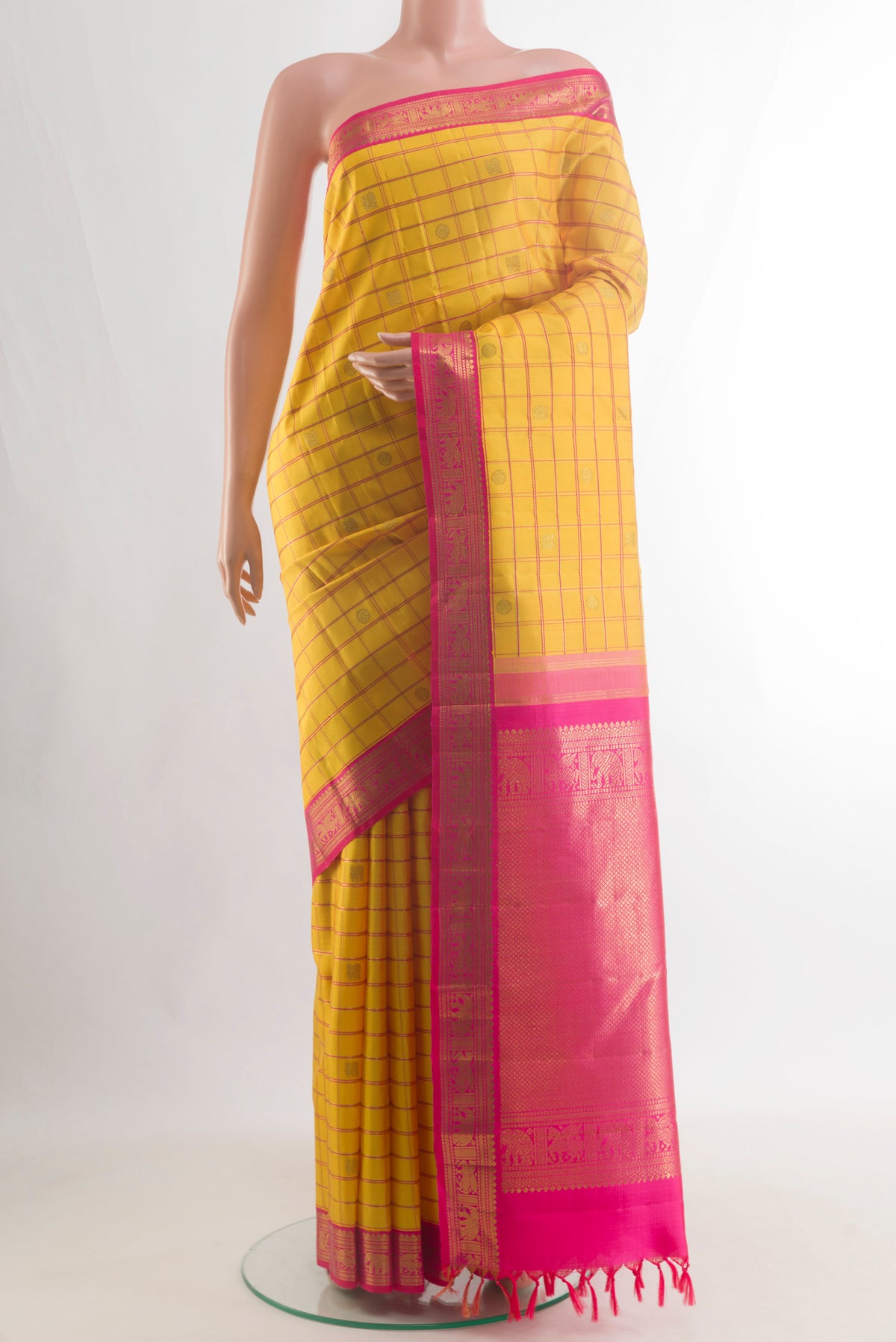 Pure Silk Pure Zari Yellow Kanchipuram Saree with Checked design on the body and Zari Border.  displayed on a mannequin