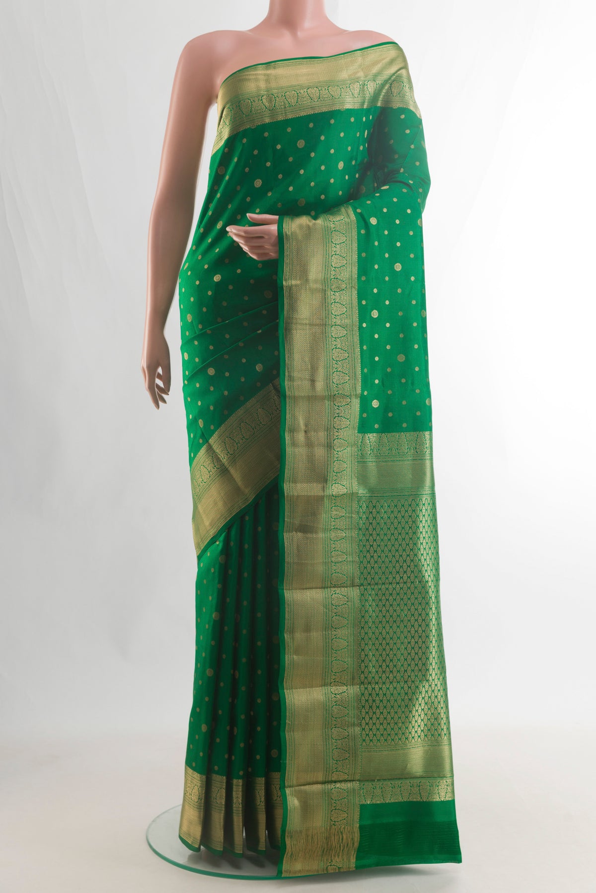 Pure Silk Green Kanjivaram Saree with Zari Butta on the body and Zari Border.  displayed on a mannequin