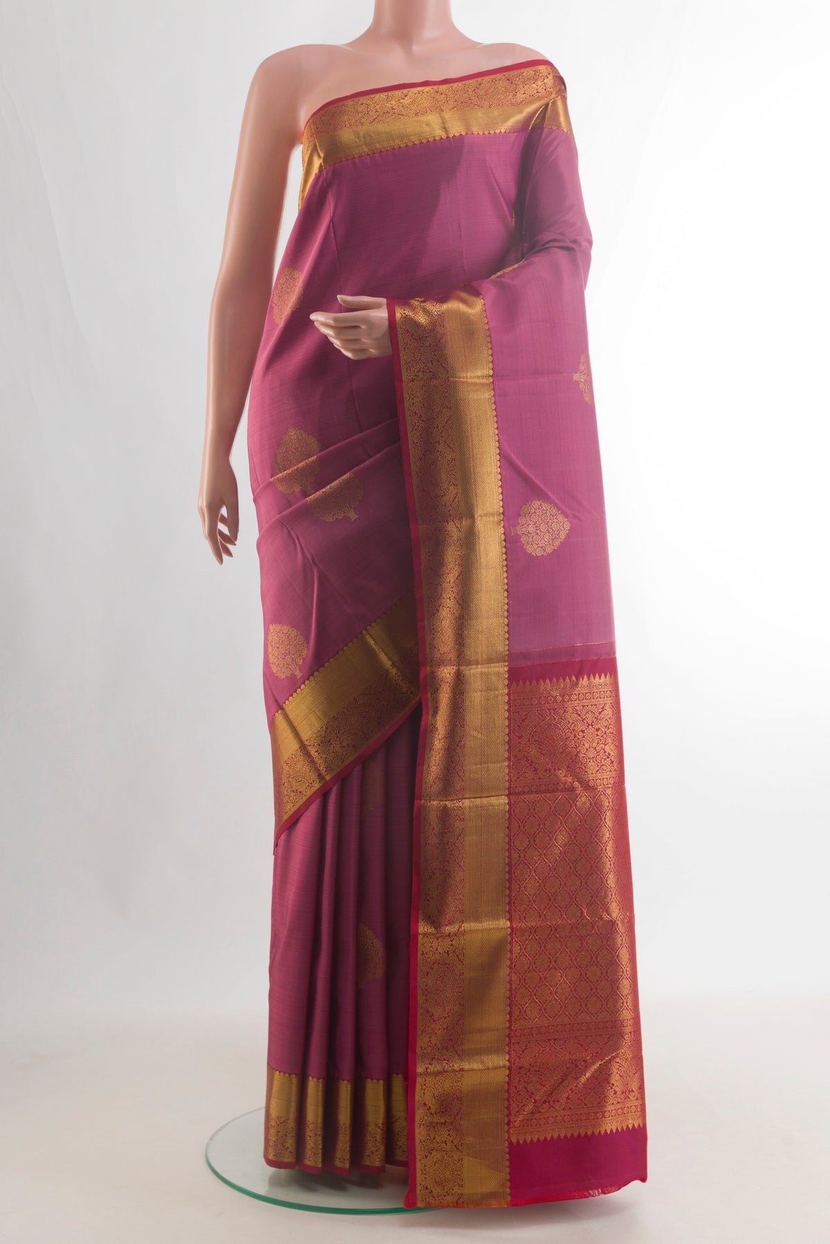 Pure Silk Pink Kanchipuram Saree with Zari Butta on the body and Zari Border.  displayed on a mannequin