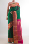 Pure Silk Green Kanchipuram Saree with Zari Butta on the body and Zari Border.  displayed on a mannequin