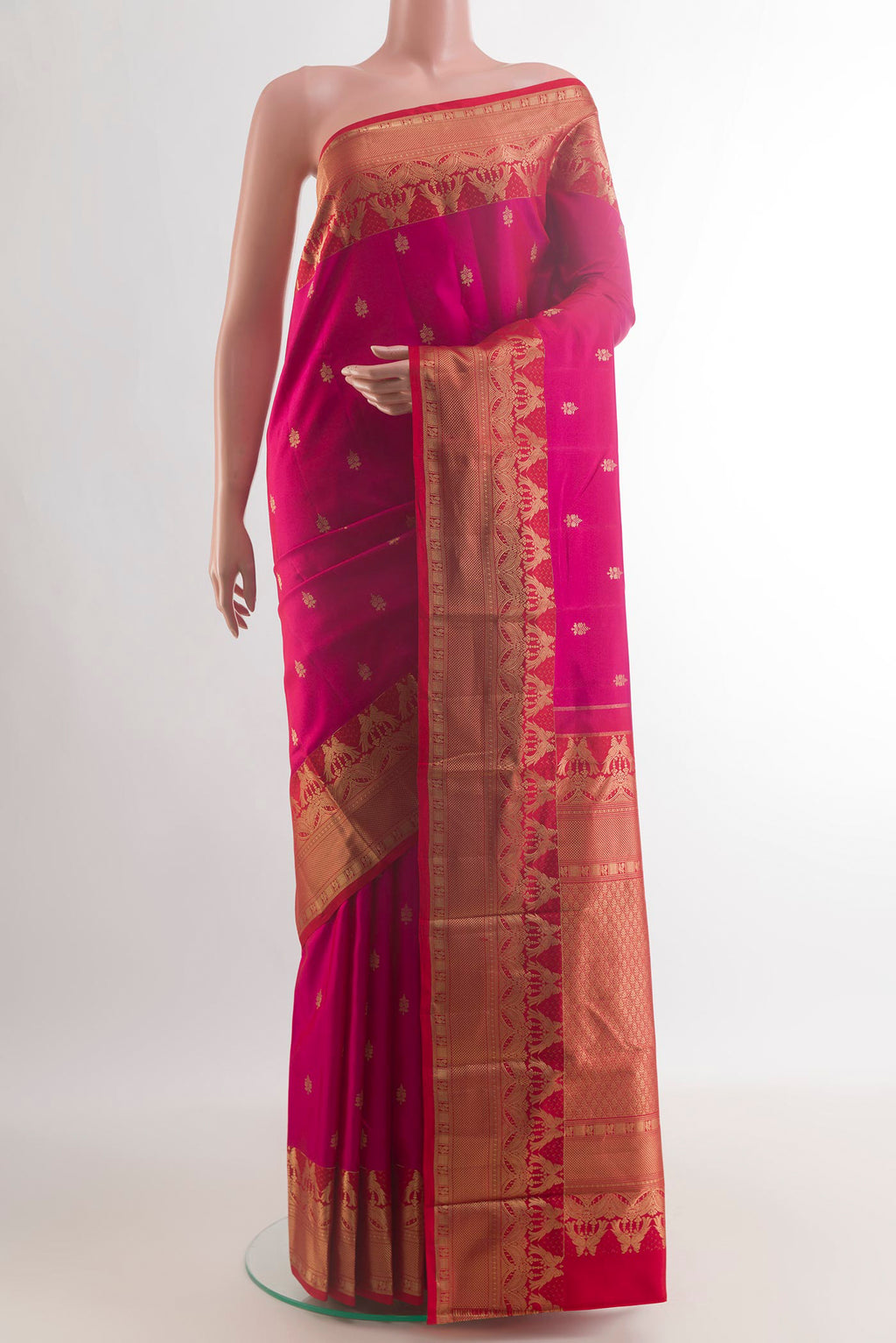 Pure Silk Pink Kanchipuram Saree with Zari Butta on the body and Zari Border.  displayed on a mannequin
