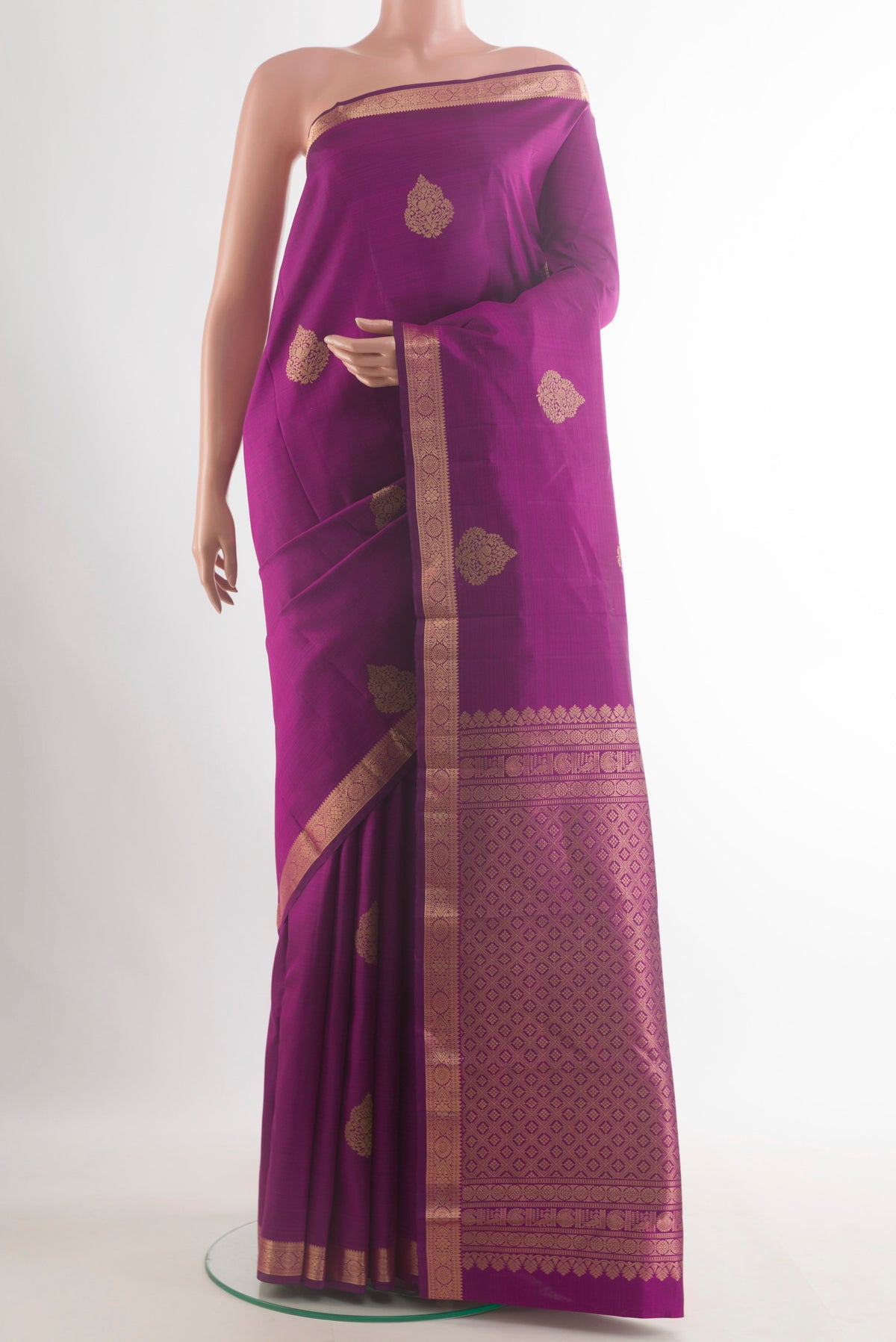 Pure Silk Purple Kanchipuram Saree with Zari Butta on the body and Zari Border.  displayed on a mannequin