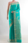 Pure Silk Sea Green Kanchipuram Saree with Zari Butta on the body and Zari Border.  displayed on a mannequin