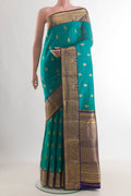 Pure Silk Sea Green Kanchipuram Saree with Zari Butta on the body and Zari Border.  displayed on a mannequin