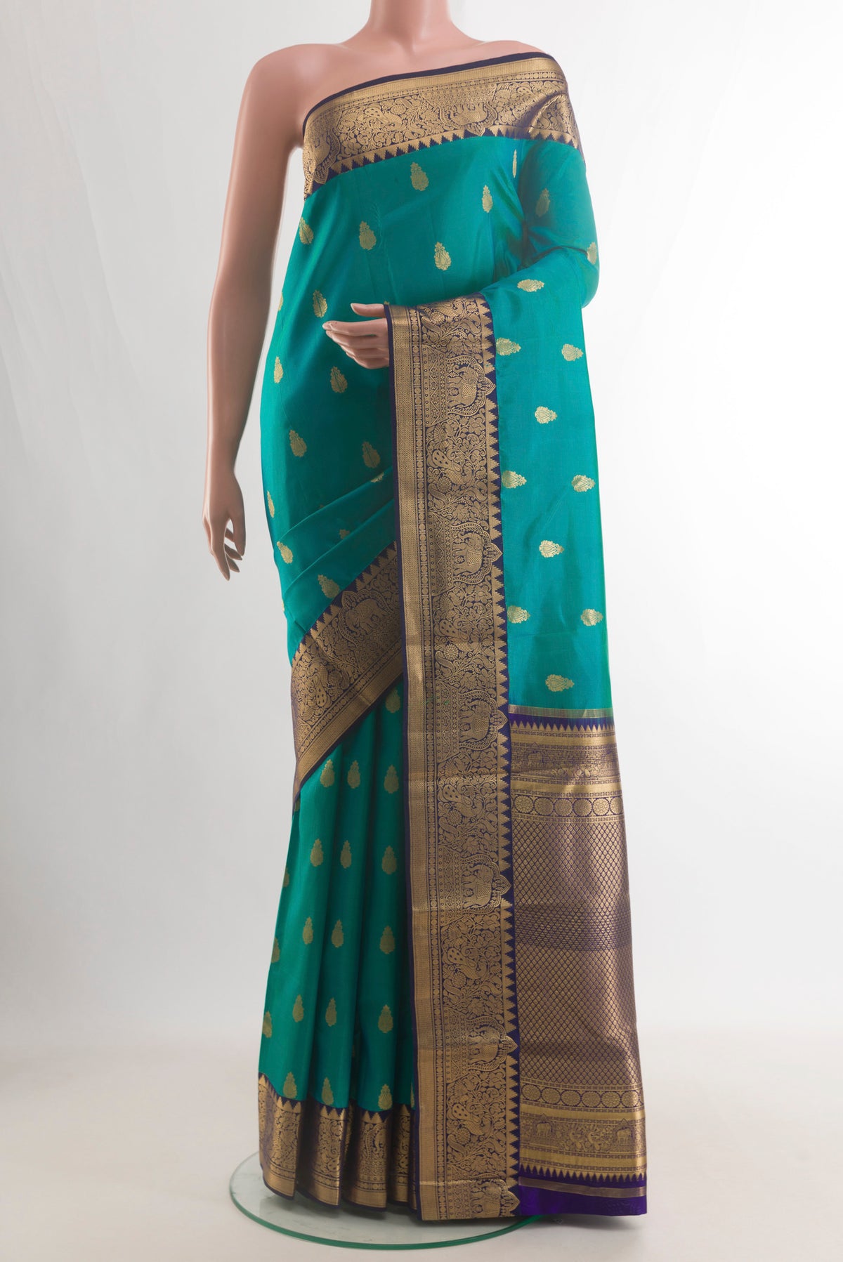 Pure Silk Sea Green Kanchipuram Saree with Zari Butta on the body and Zari Border.  displayed on a mannequin