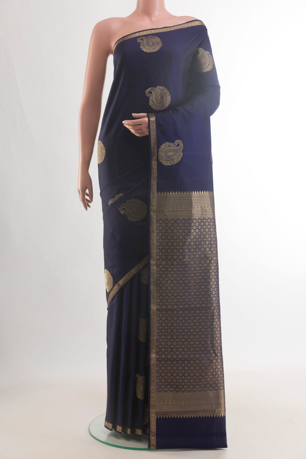 Pure Silk Navy Blue Kanchipuram Saree with Zari Butta on the body and Zari Border.  displayed on a mannequin