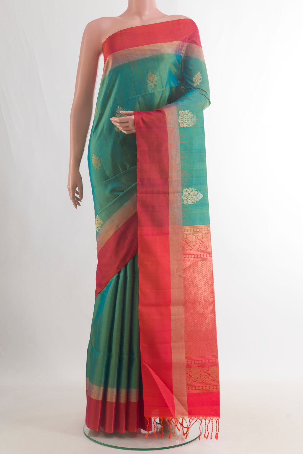 Pure Silk Green Soft Saree with Zari Butta on the body and Zari Border.  displayed on a mannequin