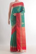Pure Silk Green Soft Saree with Zari Butta on the body and Zari Border.  displayed on a mannequin