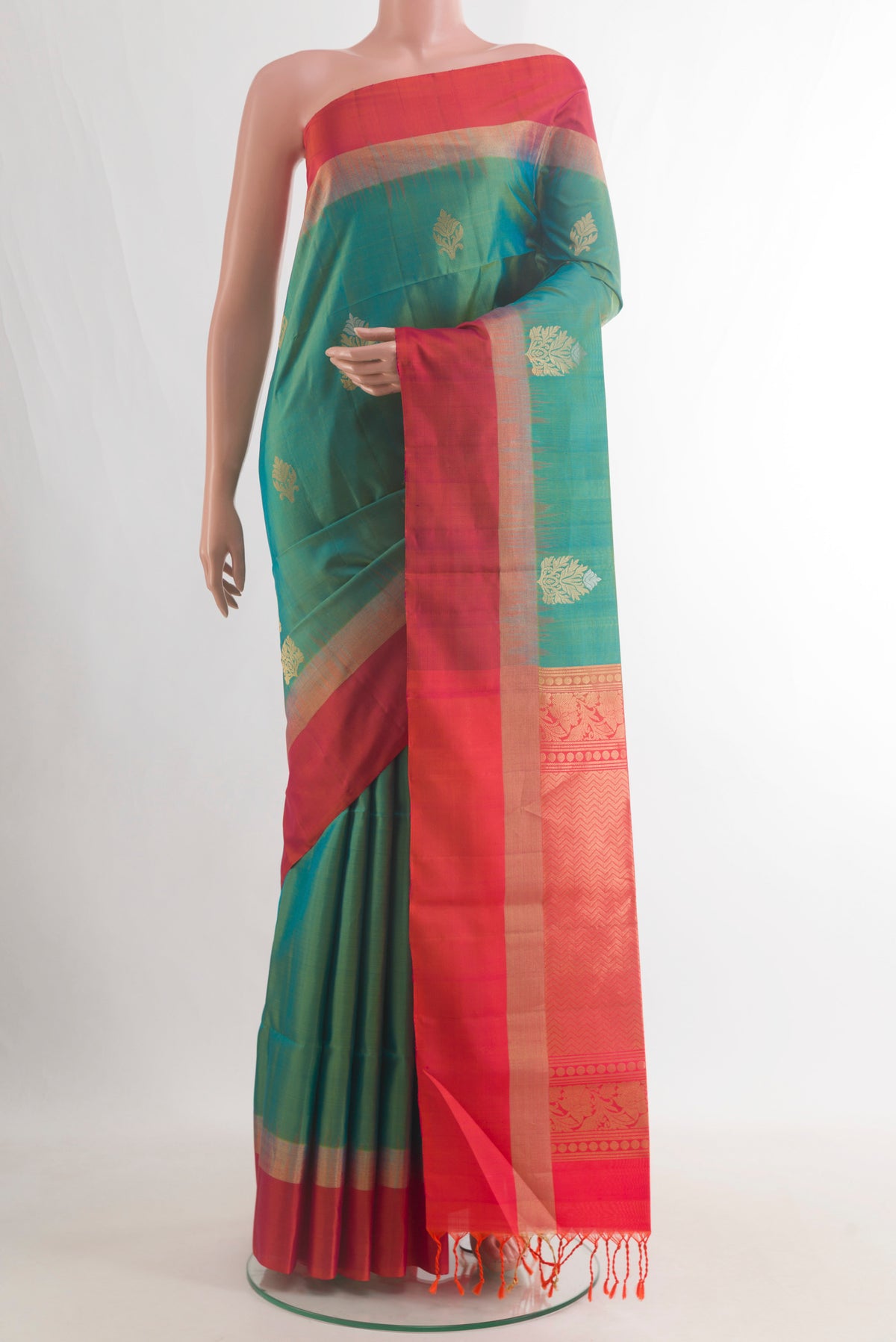 Pure Silk Green Soft Saree with Zari Butta on the body and Zari Border.  displayed on a mannequin