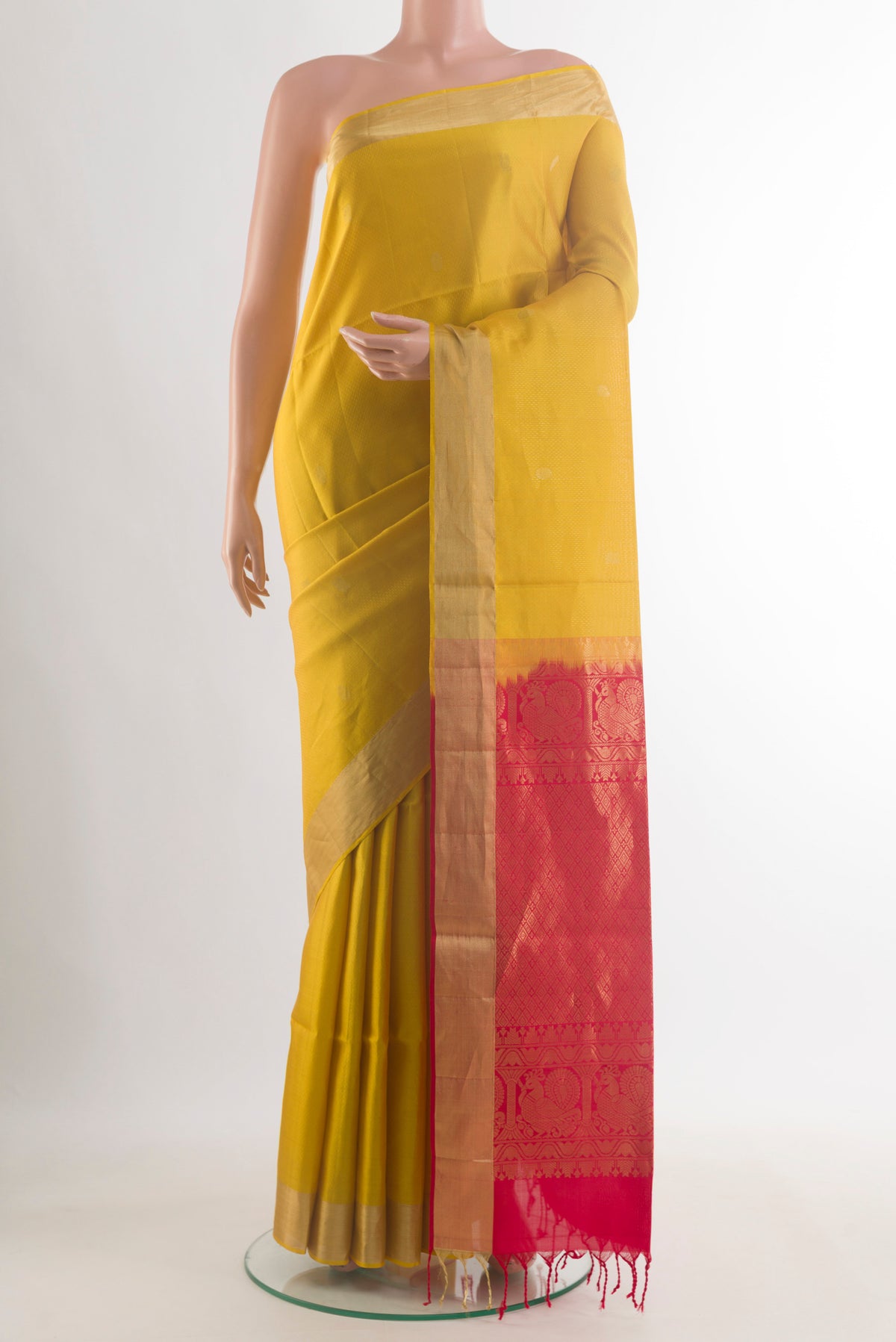 Pure Silk Yellow Soft Saree with Zari Butta on the body and Zari Border.  displayed on a mannequin