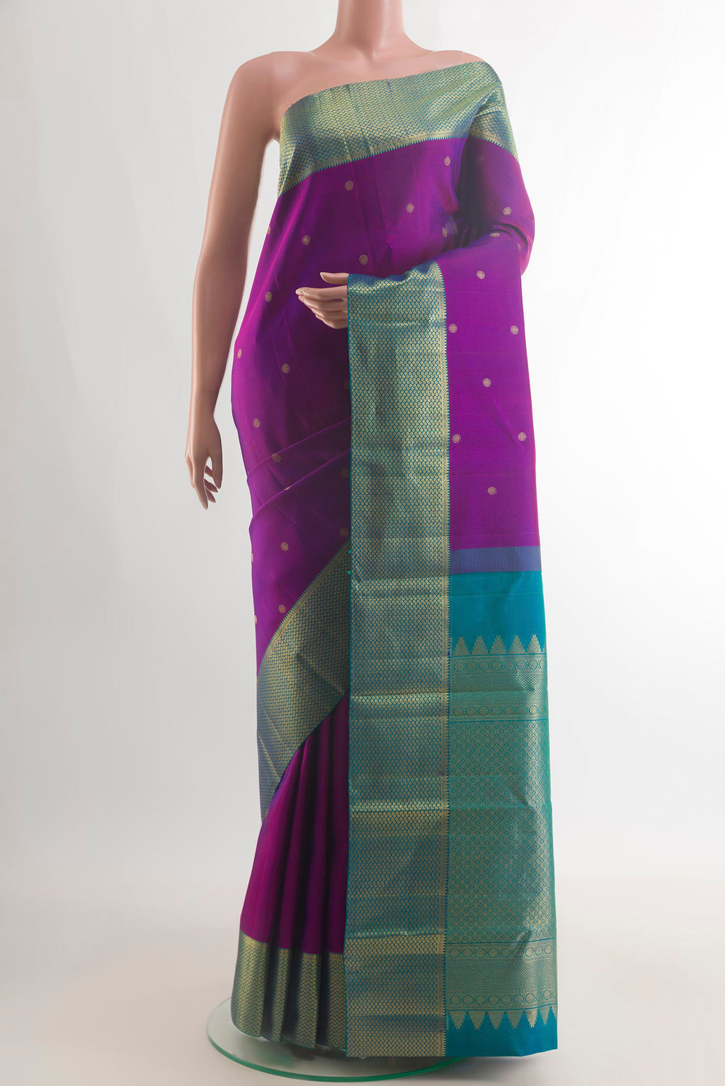 Pure Silk Purple Kanchipuram Saree with Zari Butta on the body and Zari Border.  displayed on a mannequin