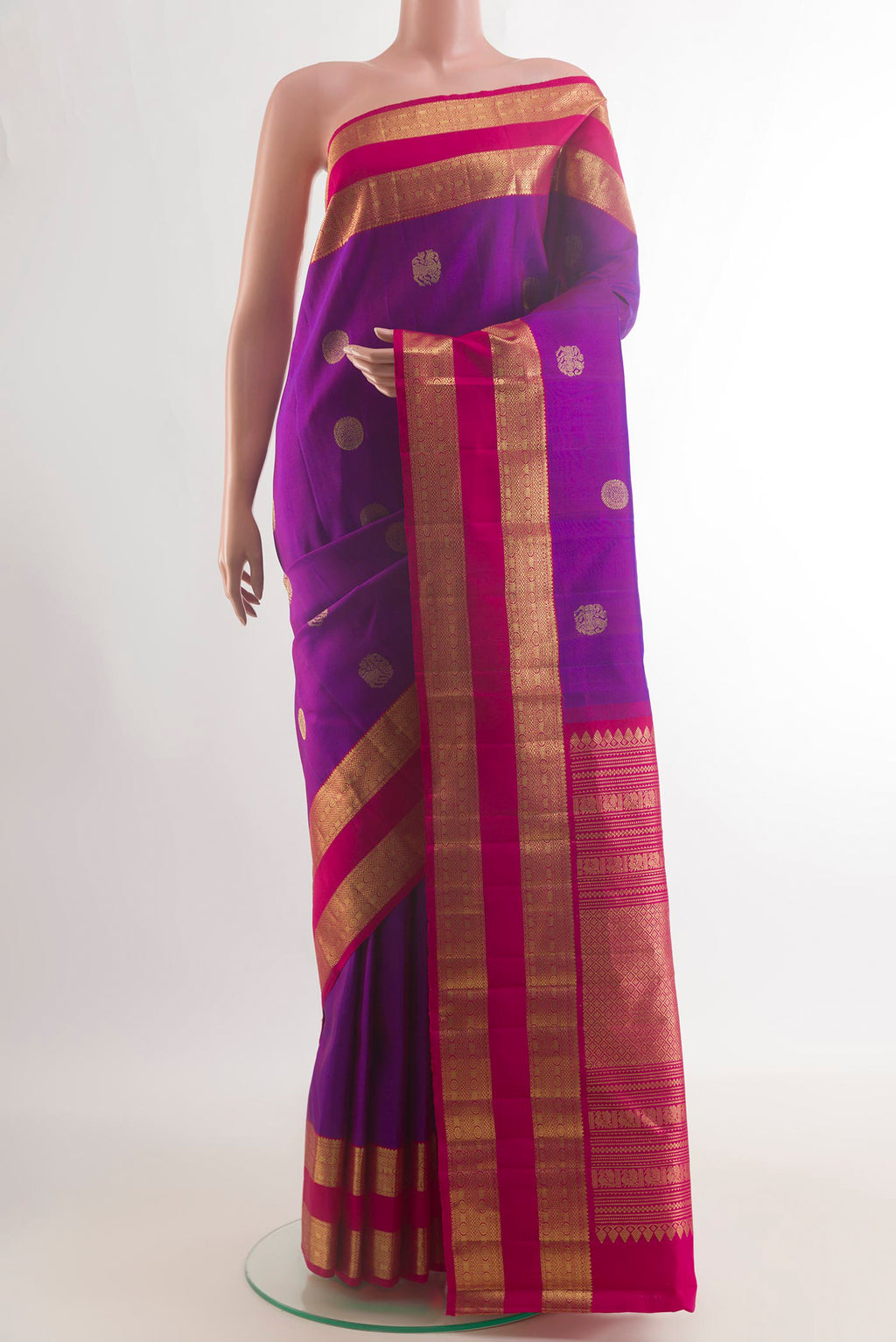 Pure Silk Purple Kanchipuram Saree with Zari Butta on the body and Zari Border.  displayed on a mannequin