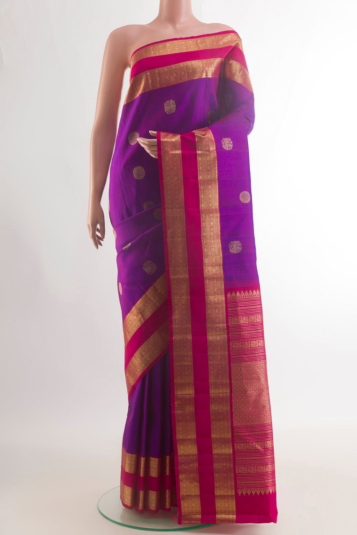 Pure Silk Purple Kanchipuram Saree with Zari Butta on the body and Zari Border.  displayed on a mannequin