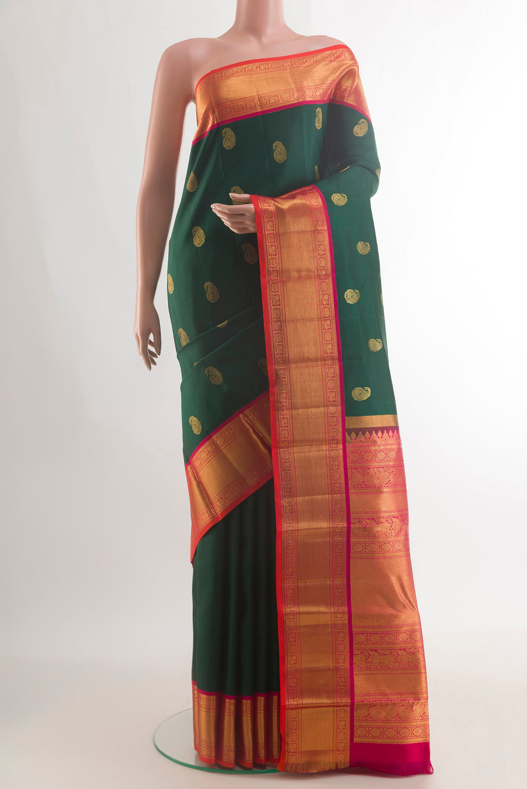 Pure Silk Bottle Green Kanjivaram Saree with Zari Butta on the body and Zari Border.  displayed on a mannequin