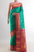 Pure Silk Green Kanjivaram Saree with Zari Butta on the body and Zari Border.  displayed on a mannequin
