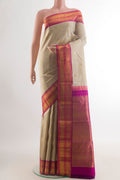 Pure Silk Beige Kanjivaram Saree with Zari Butta on the body and Zari Border.  displayed on a mannequin