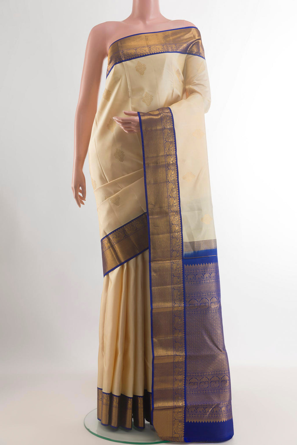 Pure Silk Cream Kanjivaram Saree with Zari Butta on the body and Zari Border.  displayed on a mannequin