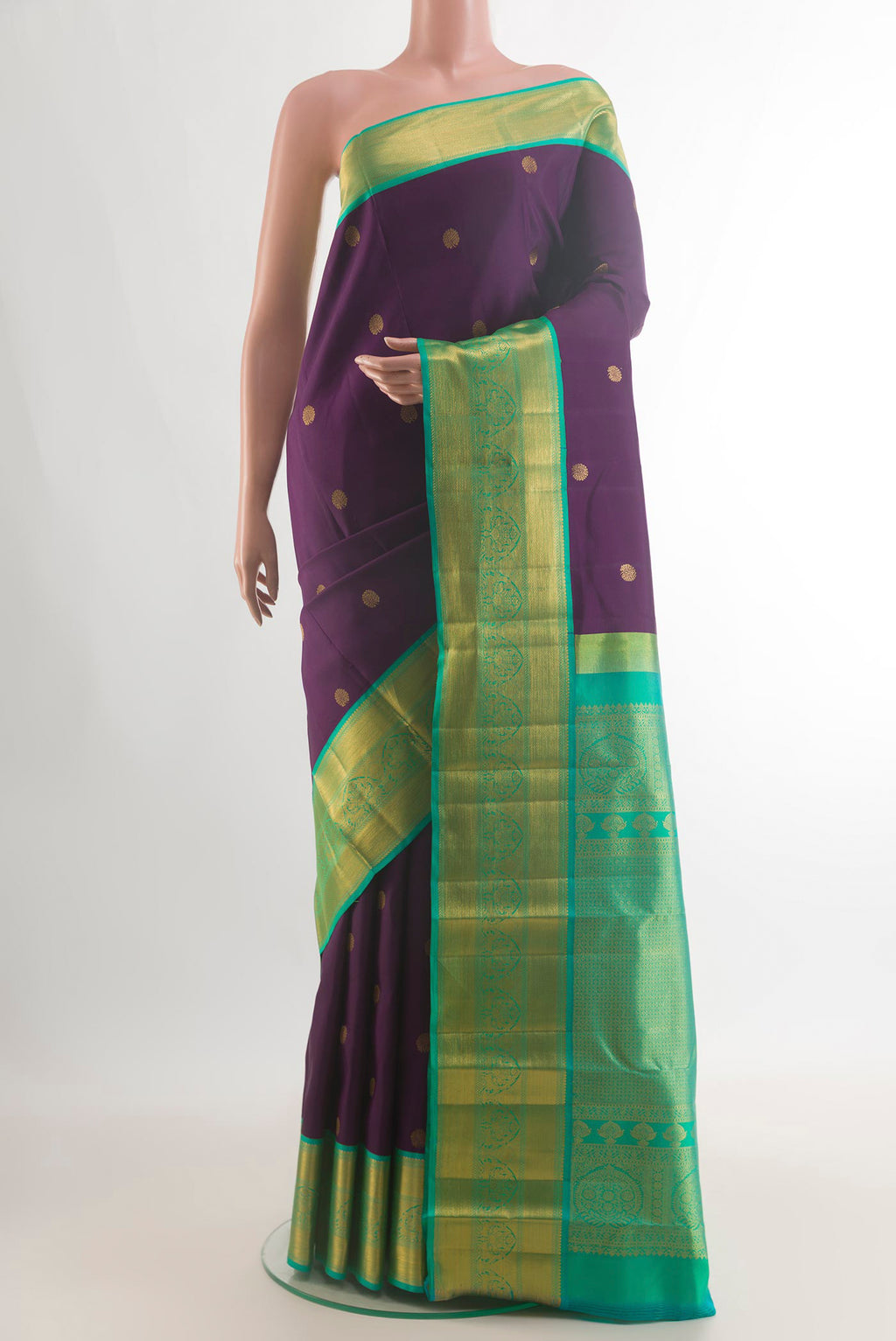 Pure Silk Purple Kanjivaram Saree with Zari Butta on the body and Zari Border.  displayed on a mannequin
