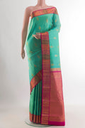 Pure Silk Green Kanchipuram Saree with Zari Butta on the body and Zari Border.  displayed on a mannequin