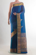 Pure Silk Peacock Blue Kanchipuram Saree with Checked design on the body and Zari Border.  displayed on a mannequin