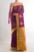 Pure Silk Magenta Kanchipuram Saree with Zari Butta on the body and Zari Border.  displayed on a mannequin