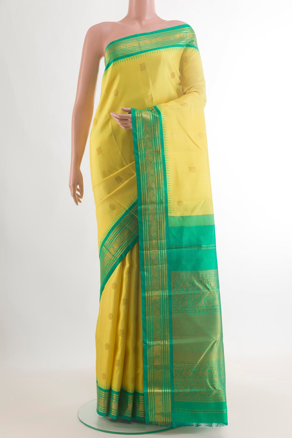 Pure Silk Yellow Kanchipuram Saree with Zari Butta on the body and Zari Border.  displayed on a mannequin