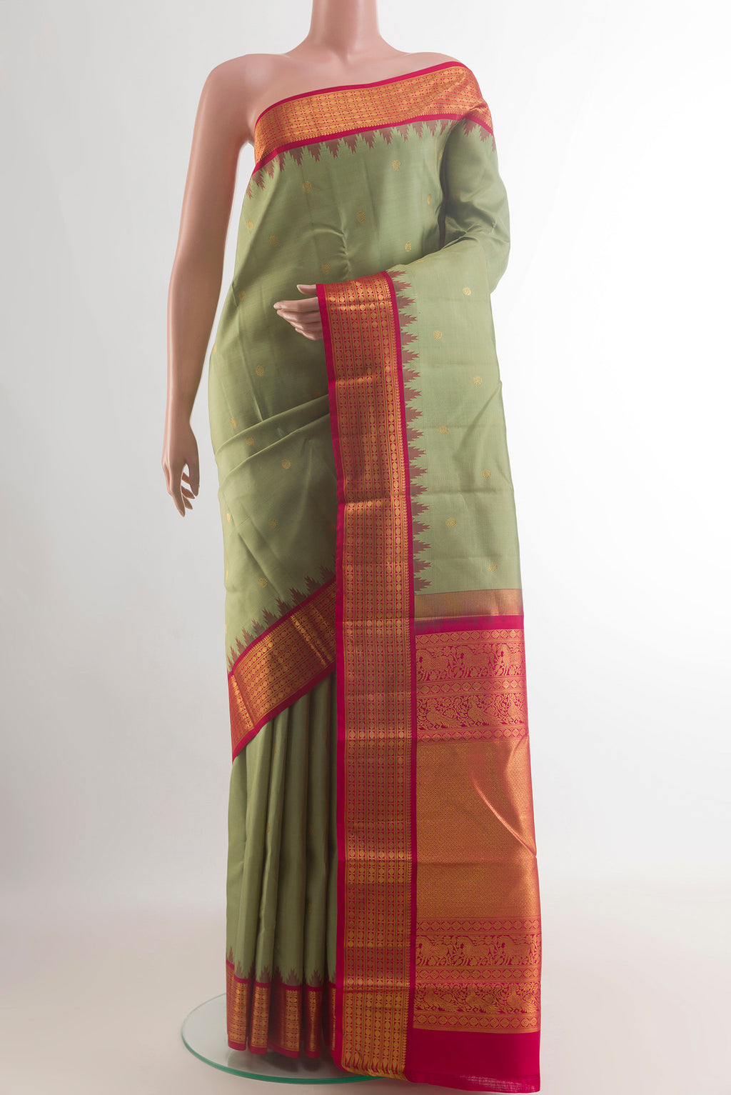 Pure Silk Sage Green Kanchipuram Saree with Zari Butta on the body and Zari Border.  displayed on a mannequin